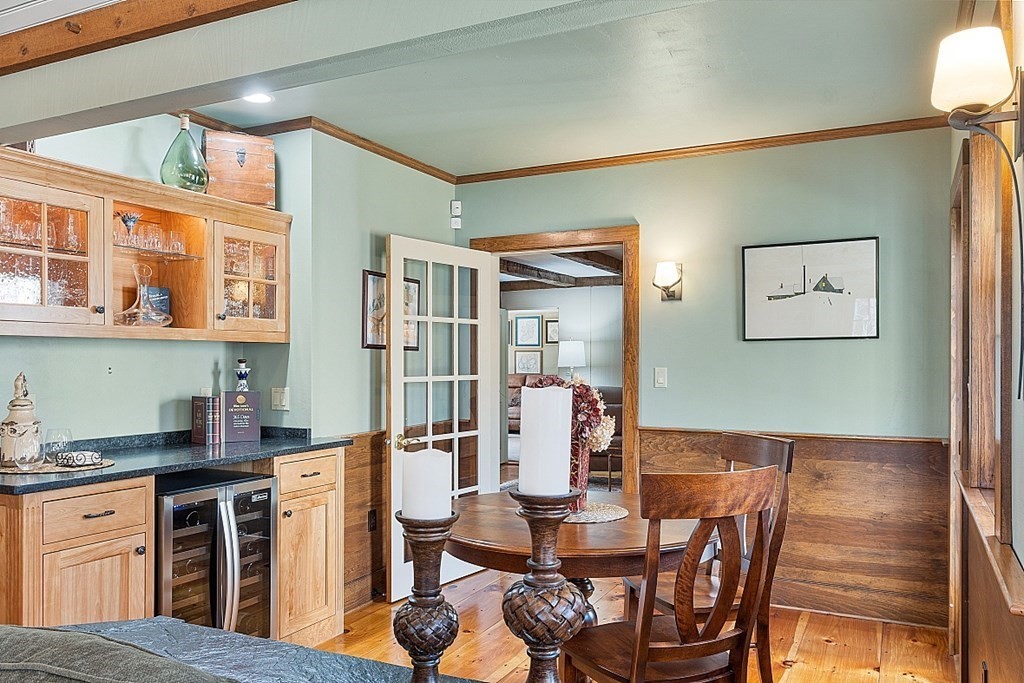 65 Lawrence Road Boxford, MA 01921 - Photo 12 of 36 a open kitchen with stainless steel appliances granite countertop a stove a refrigerator a dining table and chairs with wooden floor