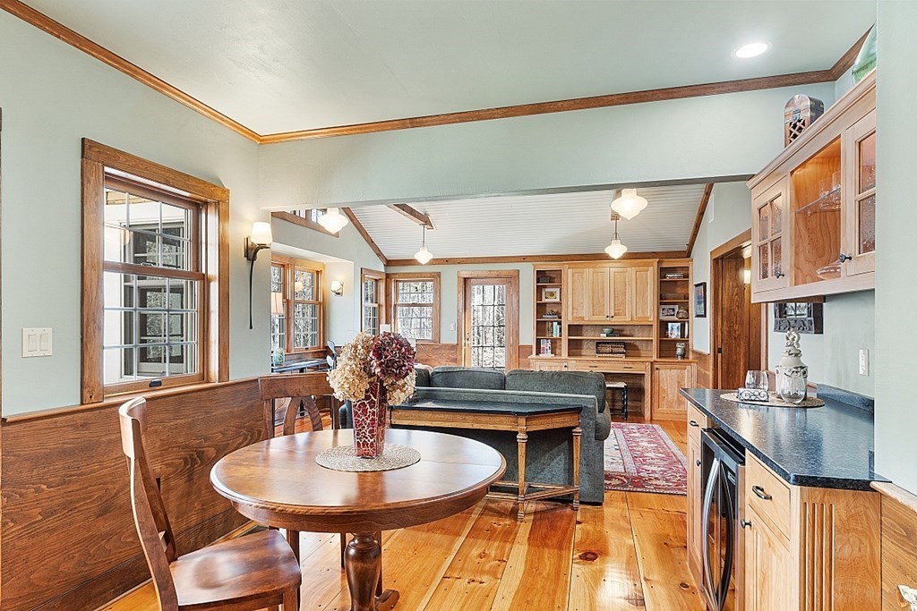 65 Lawrence Road Boxford, MA 01921 - Photo 13 of 36 a dining room with furniture a floor to ceiling window and wooden floor