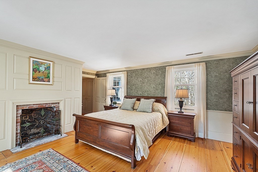 65 Lawrence Road Boxford, MA 01921 - Photo 20 of 36 a bedroom with a bed and a fireplace