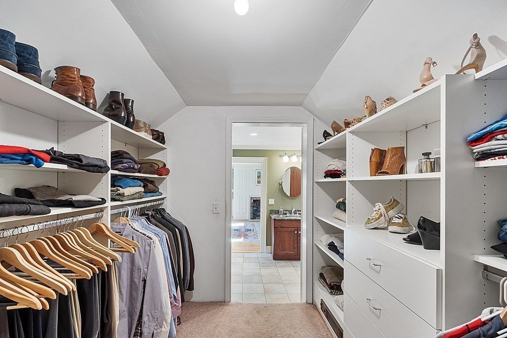 65 Lawrence Road Boxford, MA 01921 - Photo 23 of 36 a view of walk in closet with clothes and shoes