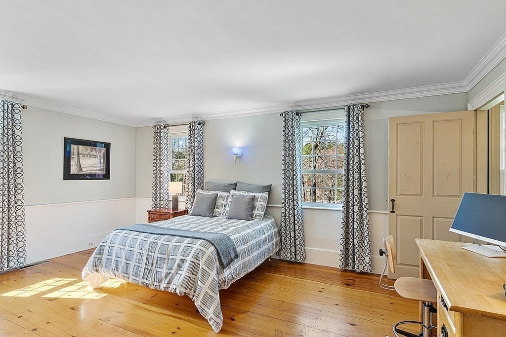 65 Lawrence Road Boxford, MA 01921 - Photo 26 of 36 a bedroom with a bed and wooden floor