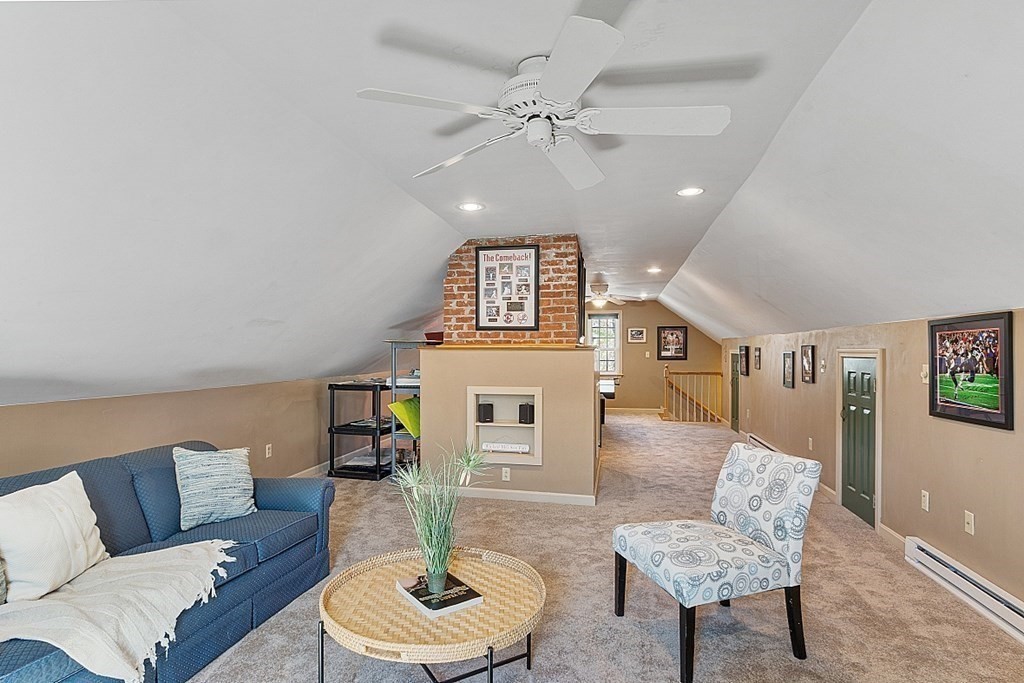 65 Lawrence Road Boxford, MA 01921 - Photo 32 of 36 a living room with furniture and a chandelier