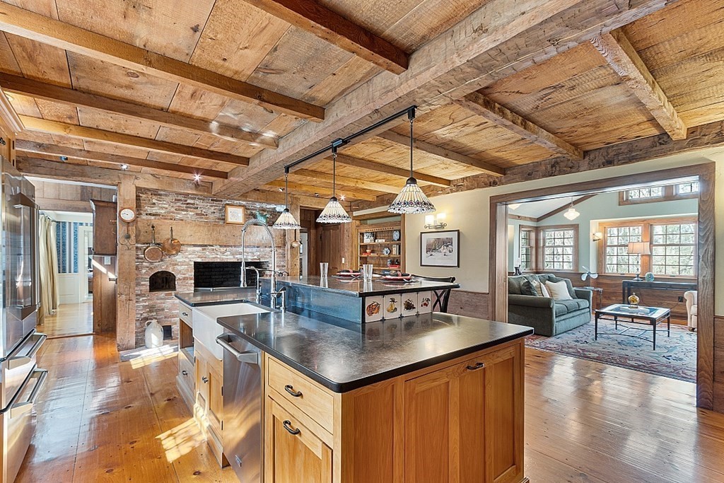 65 Lawrence Road Boxford, MA 01921 - Photo 6 of 36 a dining hall with couches a flat tv screen and couches with wooden floor