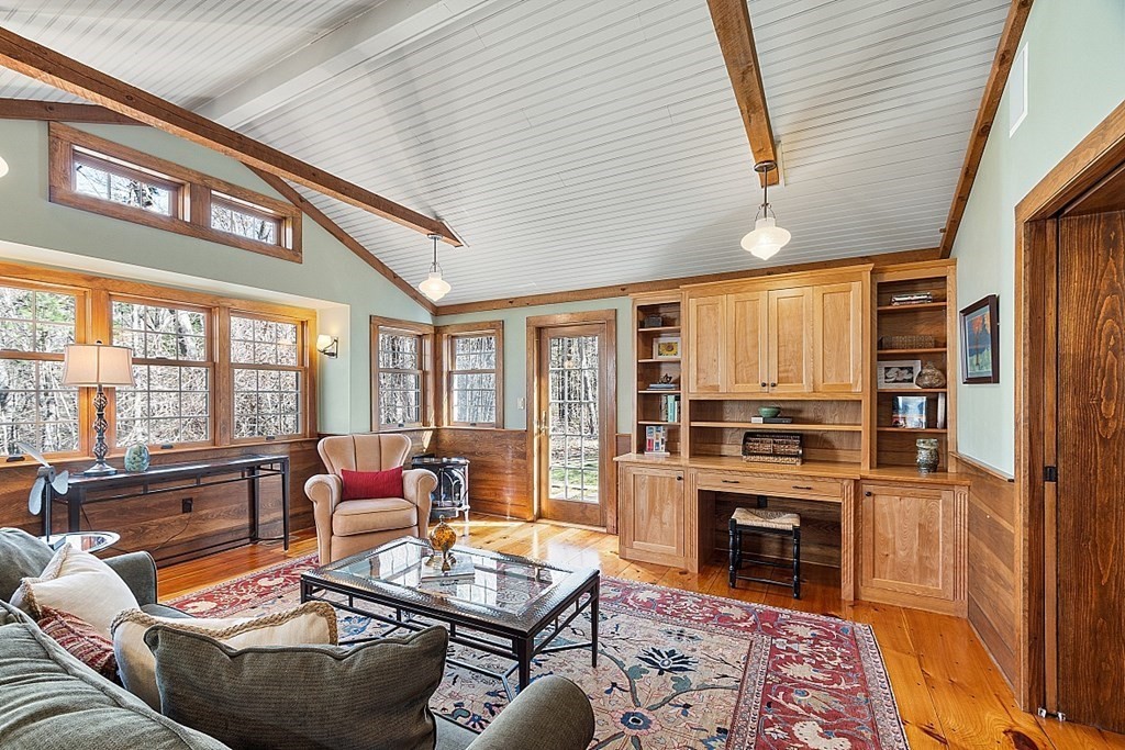 65 Lawrence Road Boxford, MA 01921 - Photo 10 of 36 a living room with furniture a fireplace and large windows