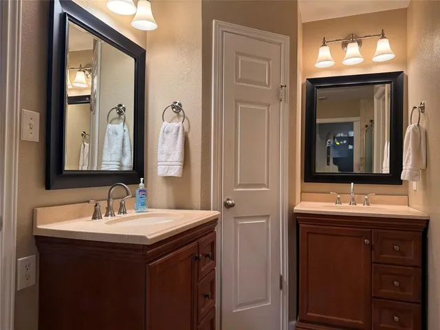 a bathroom with a double vanity sink and a mirror