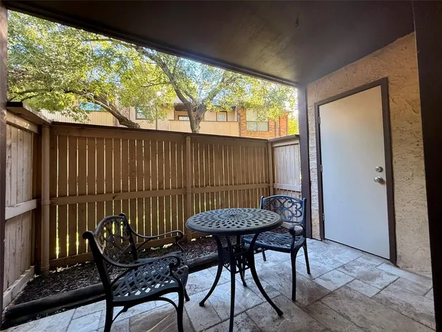 a view of a chairs and table in the balcony