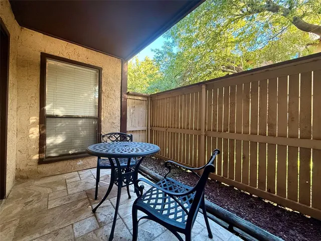 a view of balcony with two chairs and a table