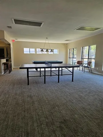 a view of a room with furniture and window