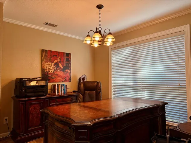 a dining room with furniture and chandelier