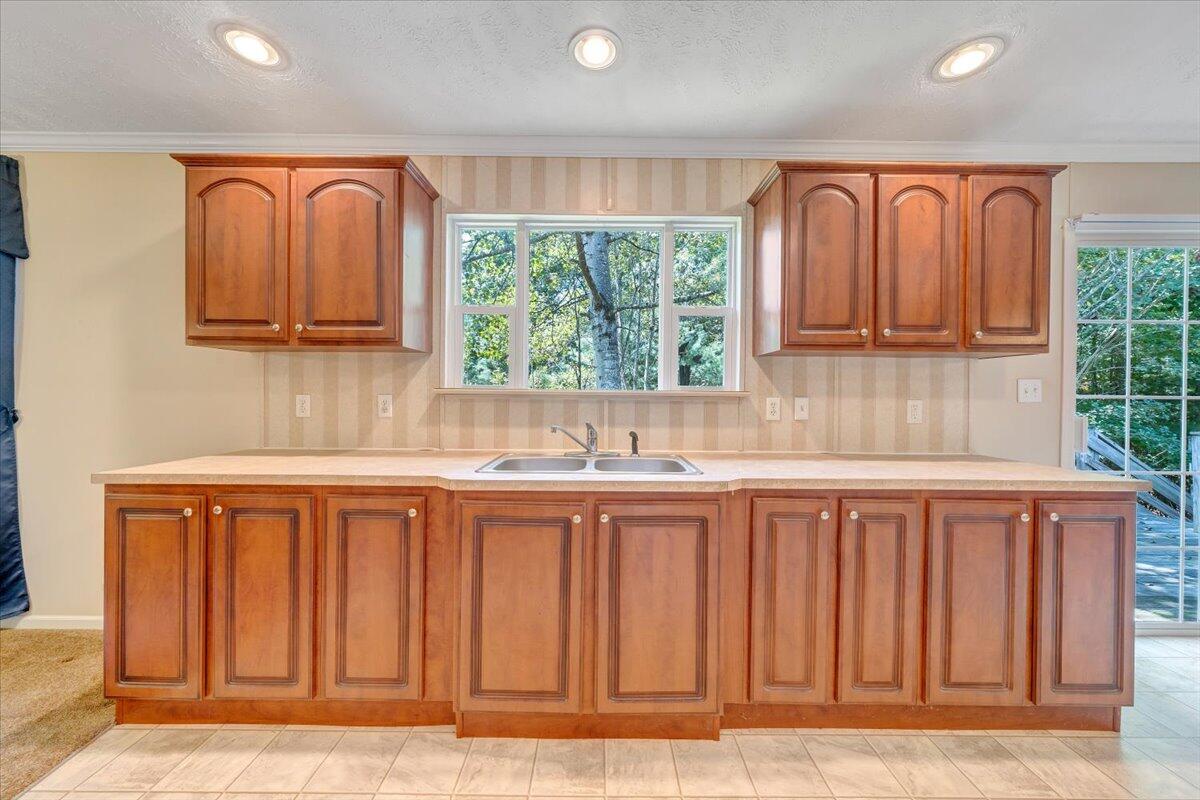 460 White Oak Road Boones Mill, VA 24065 - Photo 12 of 45 a kitchen with stainless steel appliances granite countertop a stove a sink dishwasher and a wooden cabinets