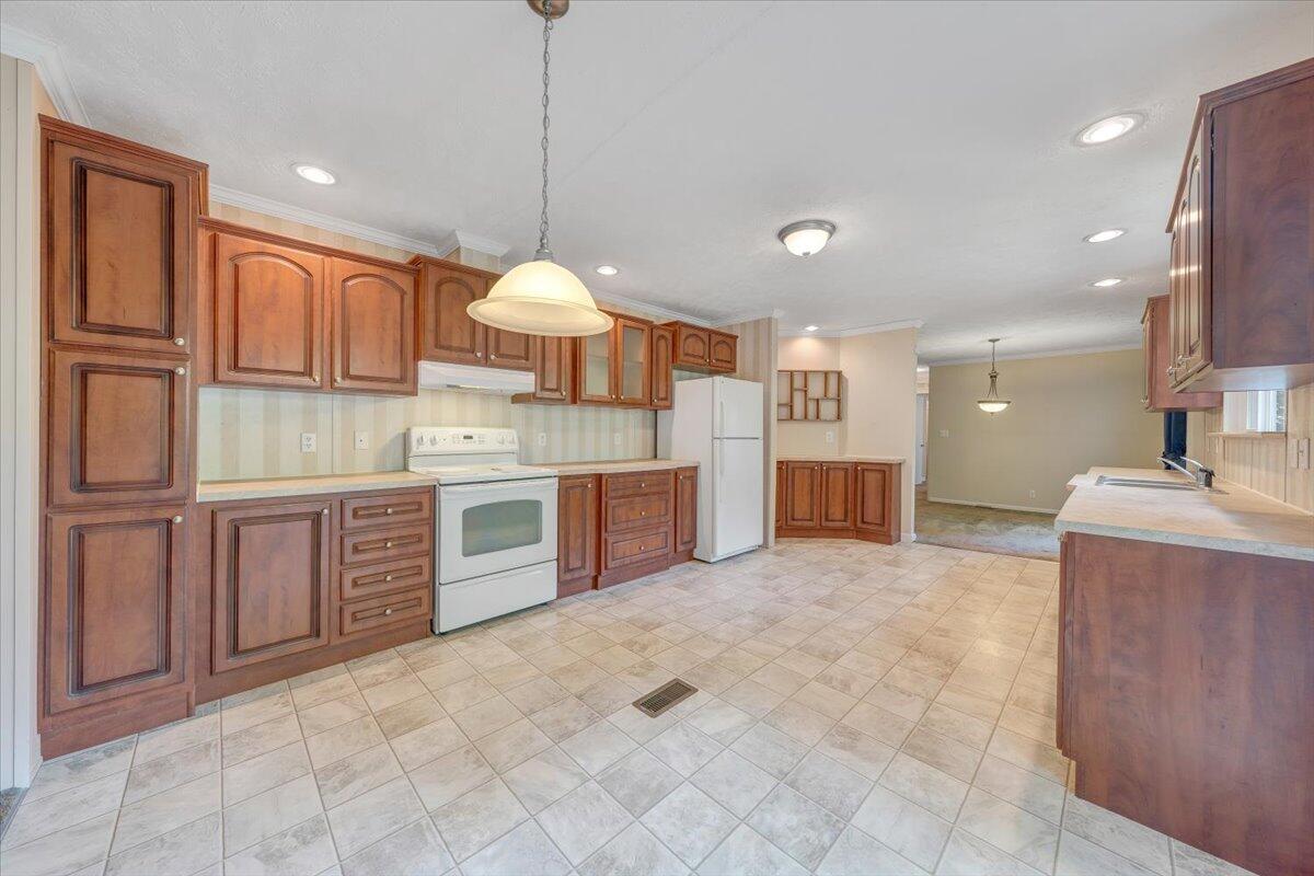 460 White Oak Road Boones Mill, VA 24065 - Photo 13 of 45 a large kitchen with a large counter top a sink stainless steel appliances and cabinets