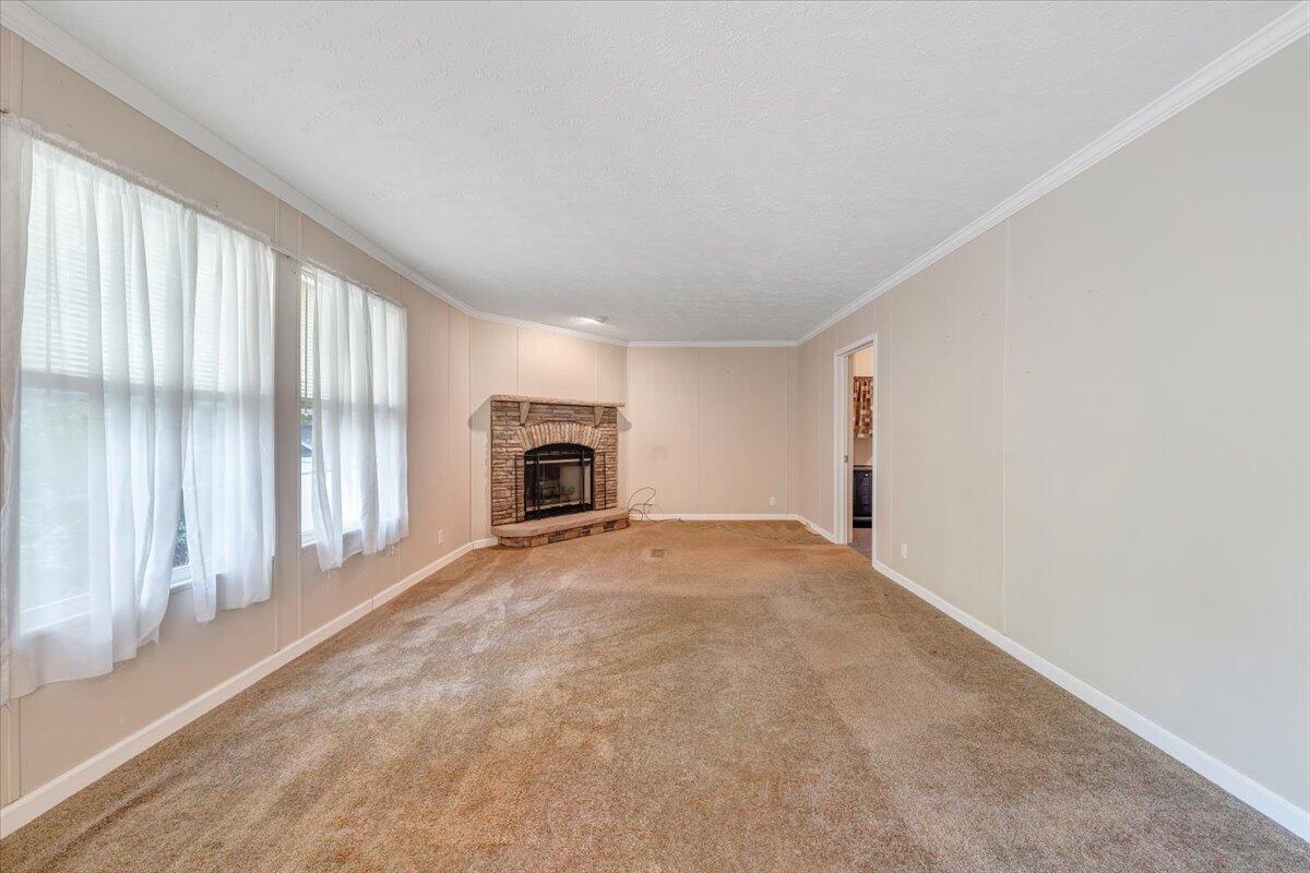 460 White Oak Road Boones Mill, VA 24065 - Photo 15 of 45 an empty room with fireplace and a window