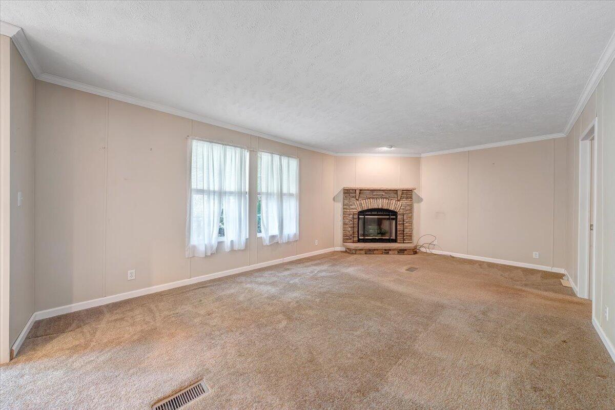 460 White Oak Road Boones Mill, VA 24065 - Photo 16 of 45 an empty room with fireplace