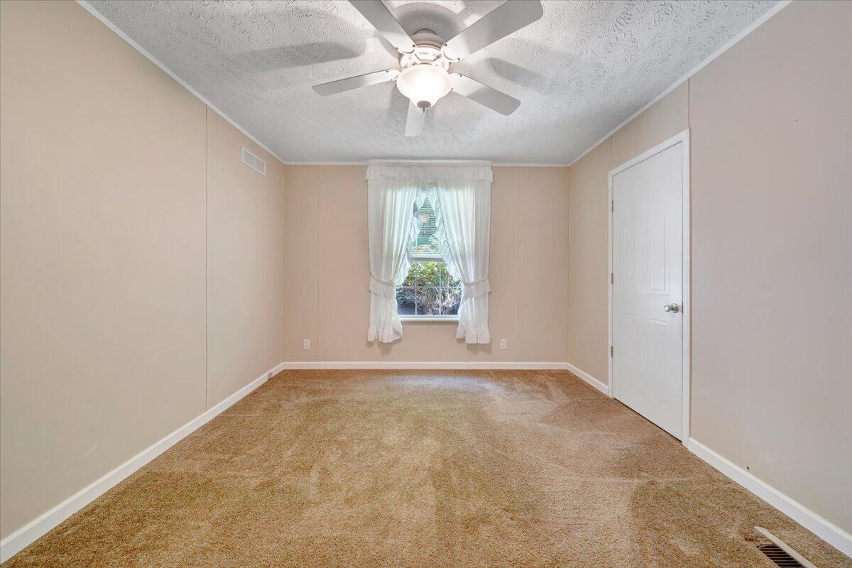 460 White Oak Road Boones Mill, VA 24065 - Photo 22 of 45 an empty room with a window and a fan