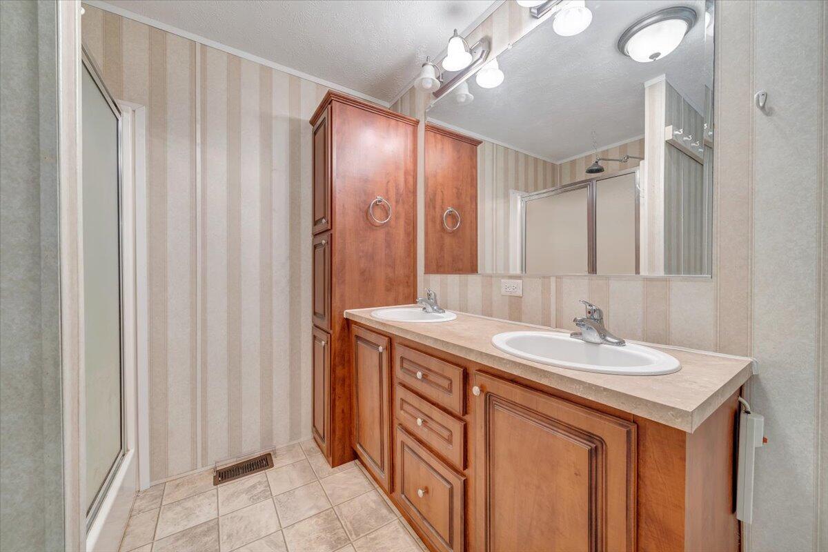 460 White Oak Road Boones Mill, VA 24065 - Photo 31 of 45 a bathroom with a double vanity sink and a mirror