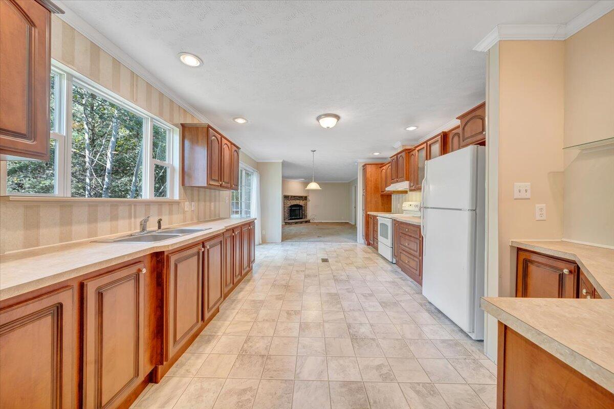 460 White Oak Road Boones Mill, VA 24065 - Photo 10 of 45 a kitchen with stainless steel appliances granite countertop a refrigerator and a sink
