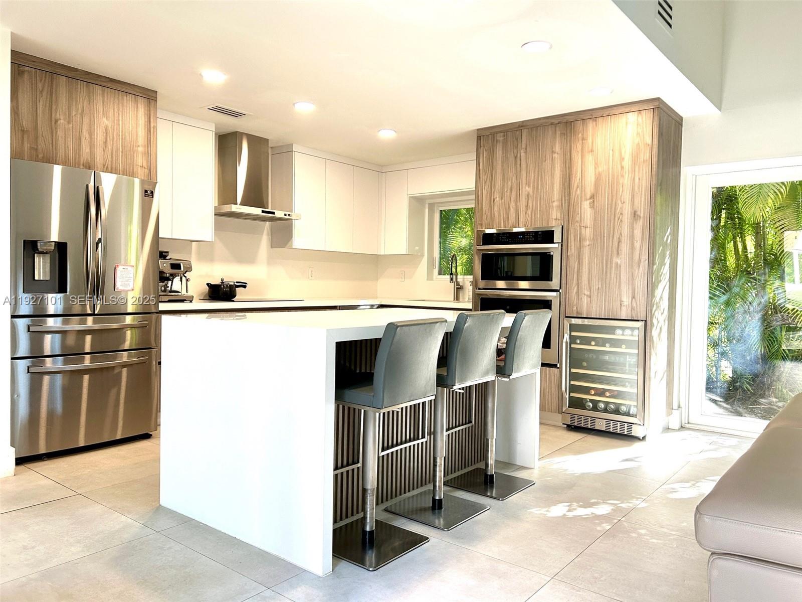 4445 Red Road Coral Gables, FL 33146 - Photo 11 of 41 a kitchen with stainless steel appliances granite countertop a refrigerator a stove a sink a microwave and island