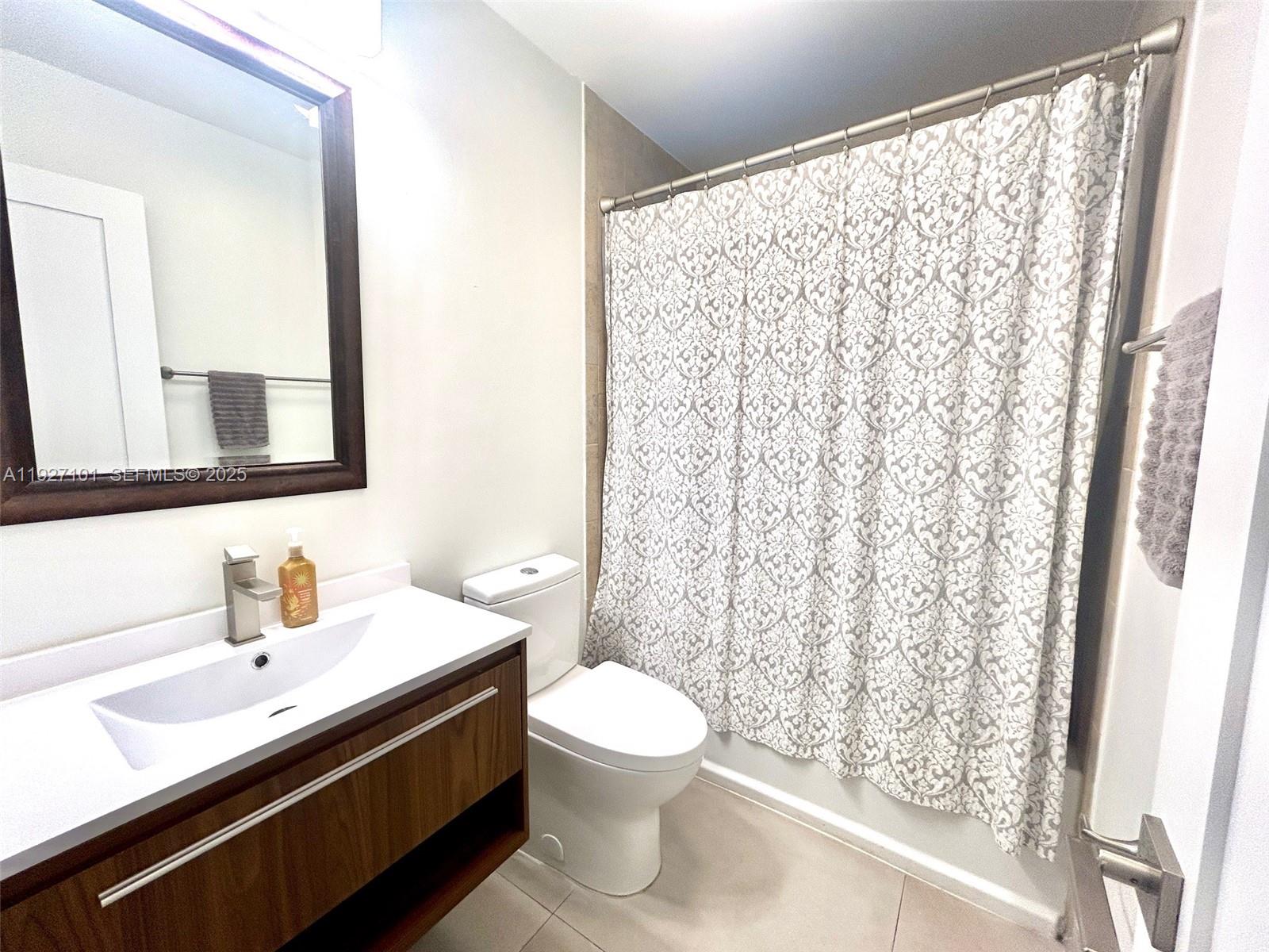 4445 Red Road Coral Gables, FL 33146 - Photo 20 of 41 a bathroom with a double vanity sink toilet and a mirror