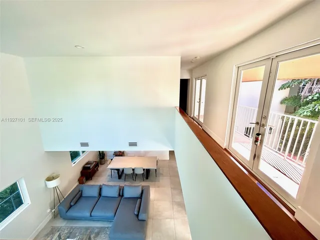 a view of a living room with furniture and a large window