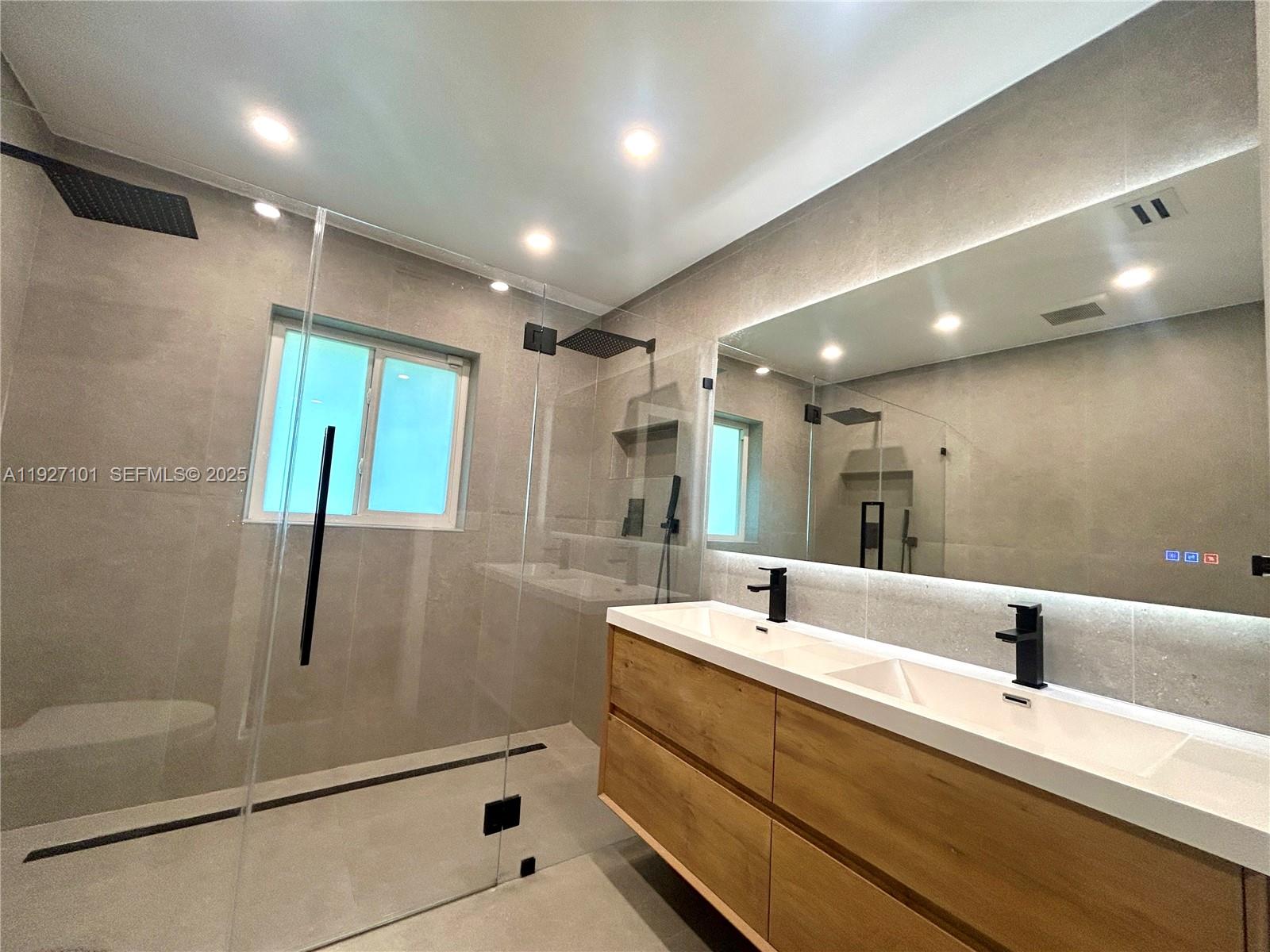 4445 Red Road Coral Gables, FL 33146 - Photo 35 of 41 a bathroom with a double vanity sink a mirror and shower