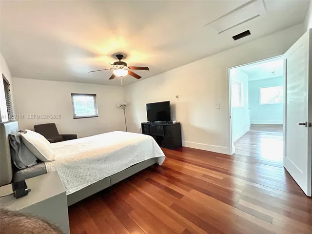 a spacious bedroom with a bed and a chandelier