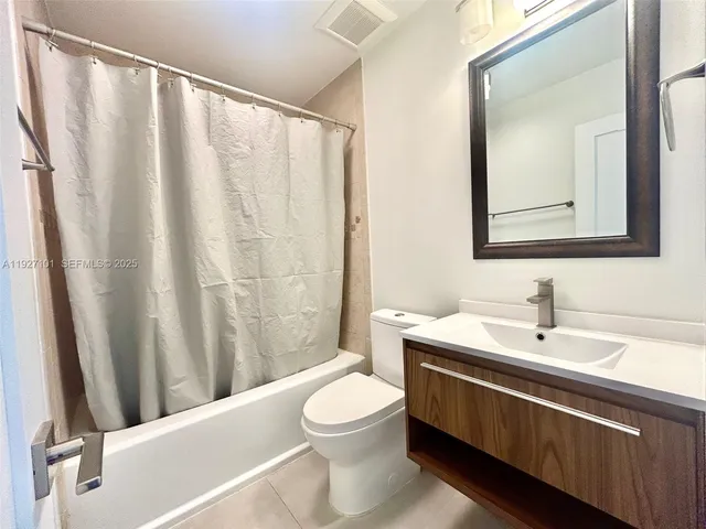 a bathroom with a toilet a sink and a mirror