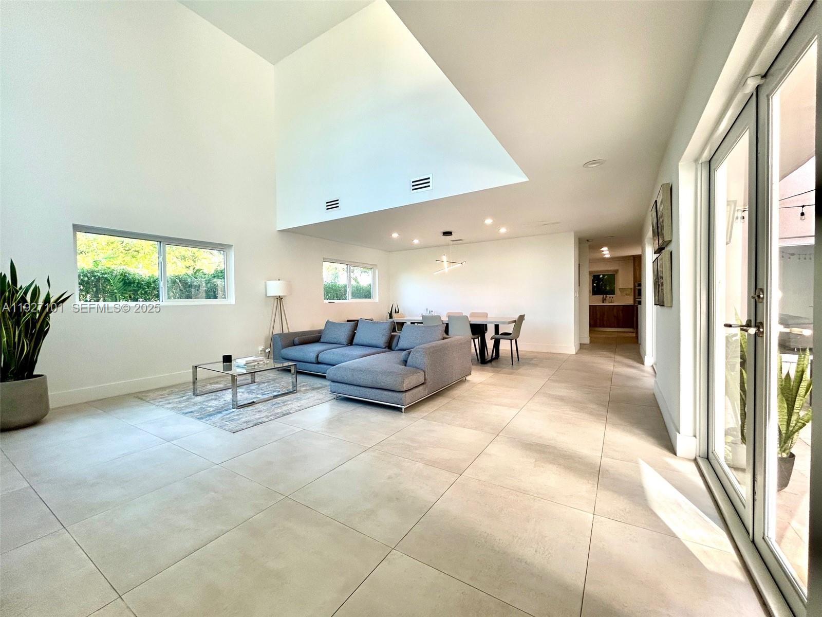 4445 Red Road Coral Gables, FL 33146 - Photo 5 of 41 a living room with furniture and a flat screen tv