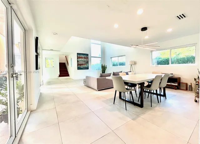 a large kitchen with a table and chairs