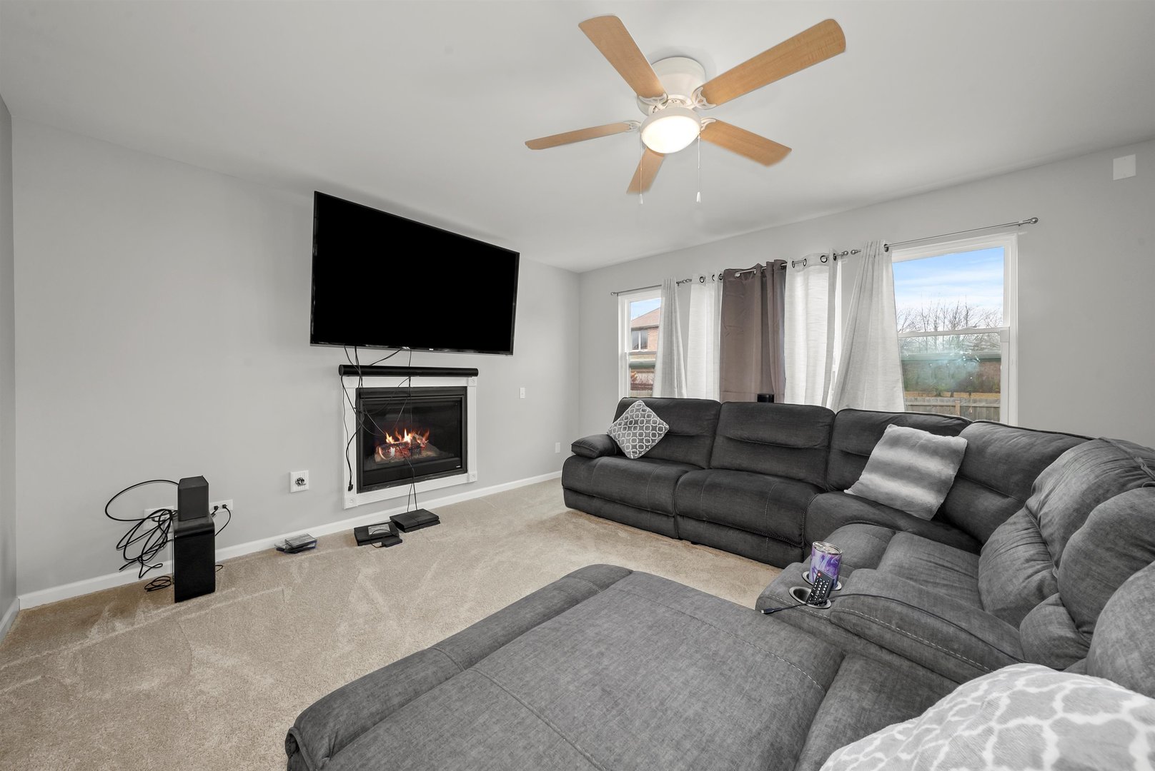 1516 Perry Street Crete, IL 60417 - Photo 12 of 35 a living room with furniture a flat screen tv and a fireplace