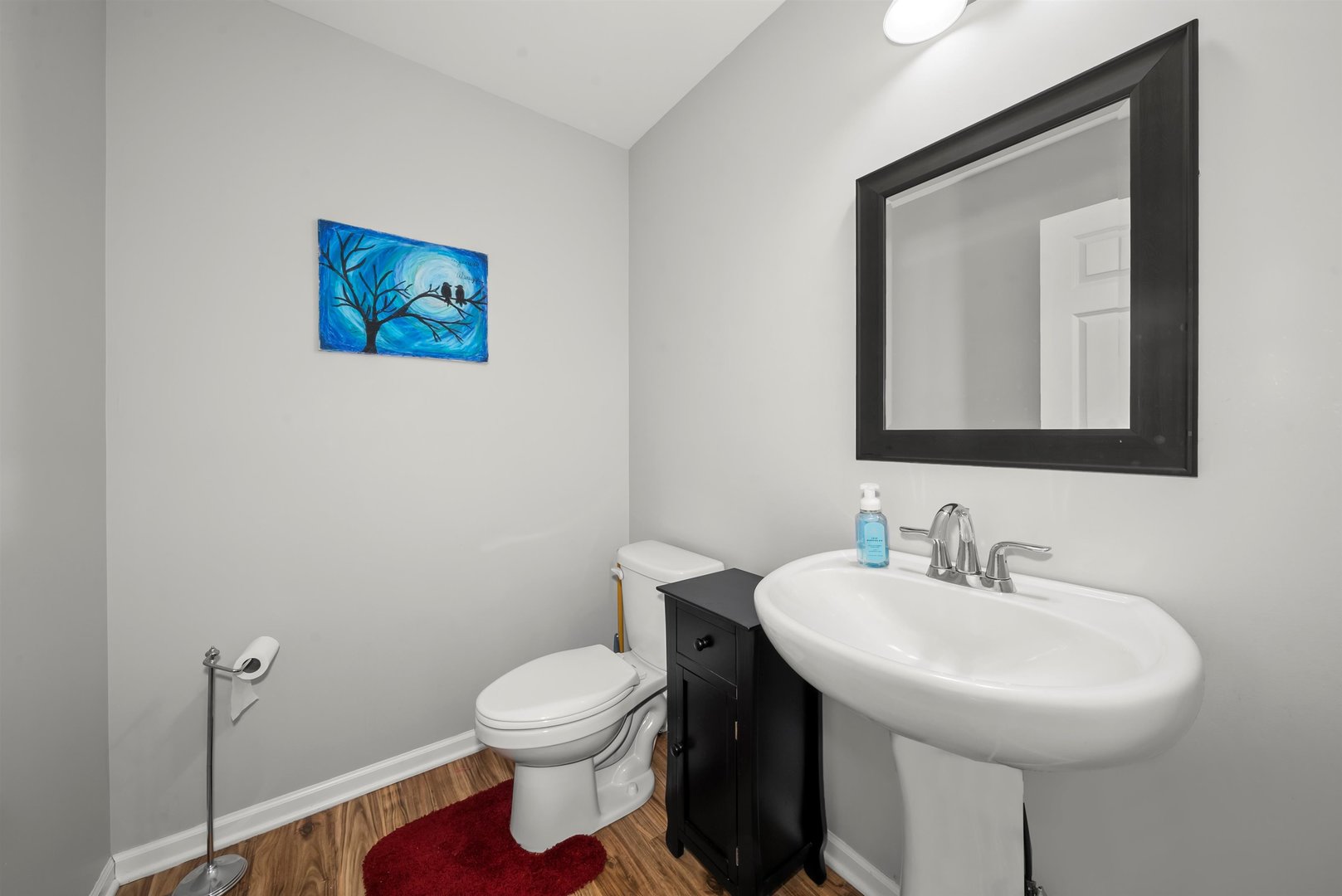 1516 Perry Street Crete, IL 60417 - Photo 14 of 35 a bathroom with a toilet a sink and mirror