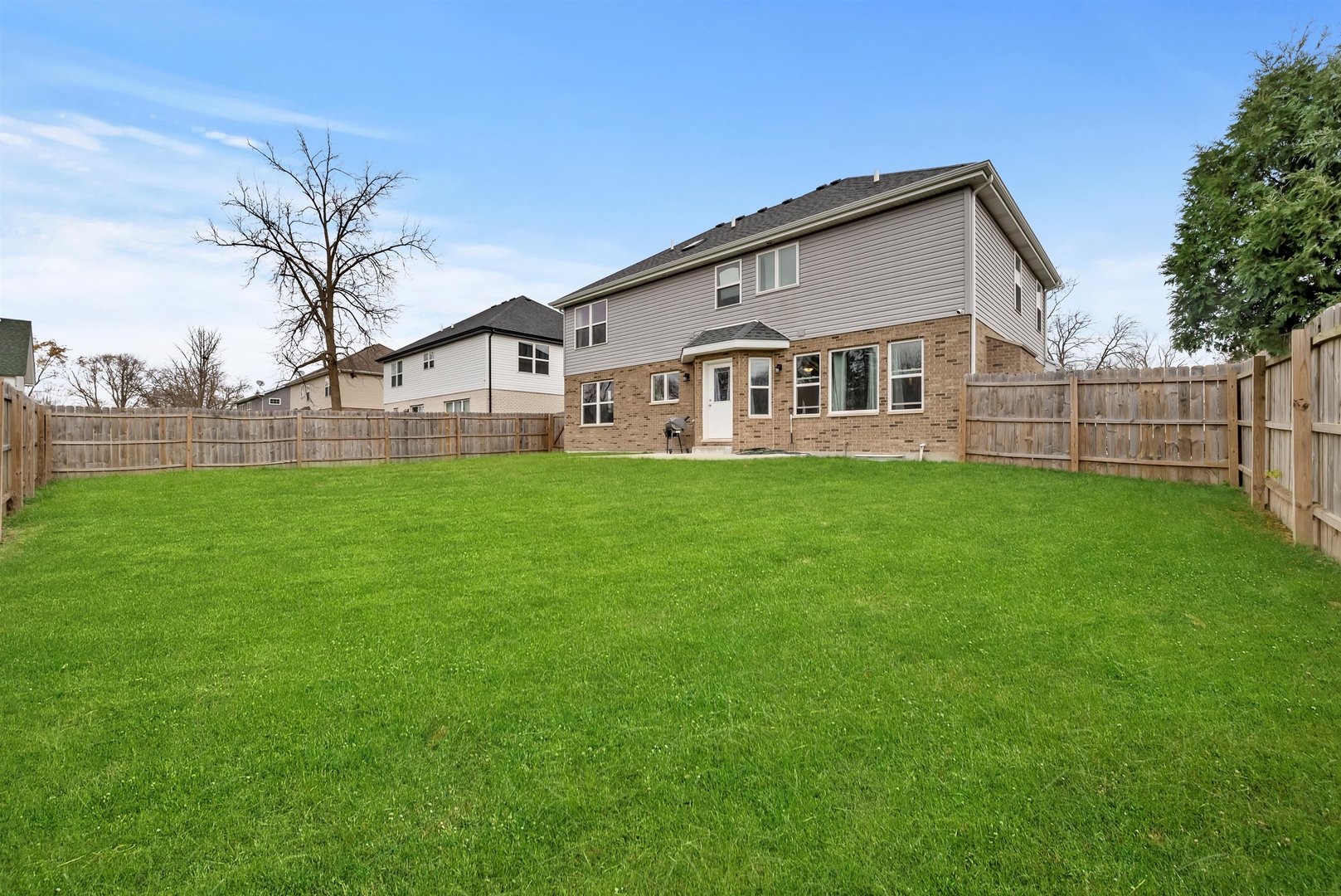 1516 Perry Street Crete, IL 60417 - Photo 25 of 35 a view of a yard in front of a house with a large tree