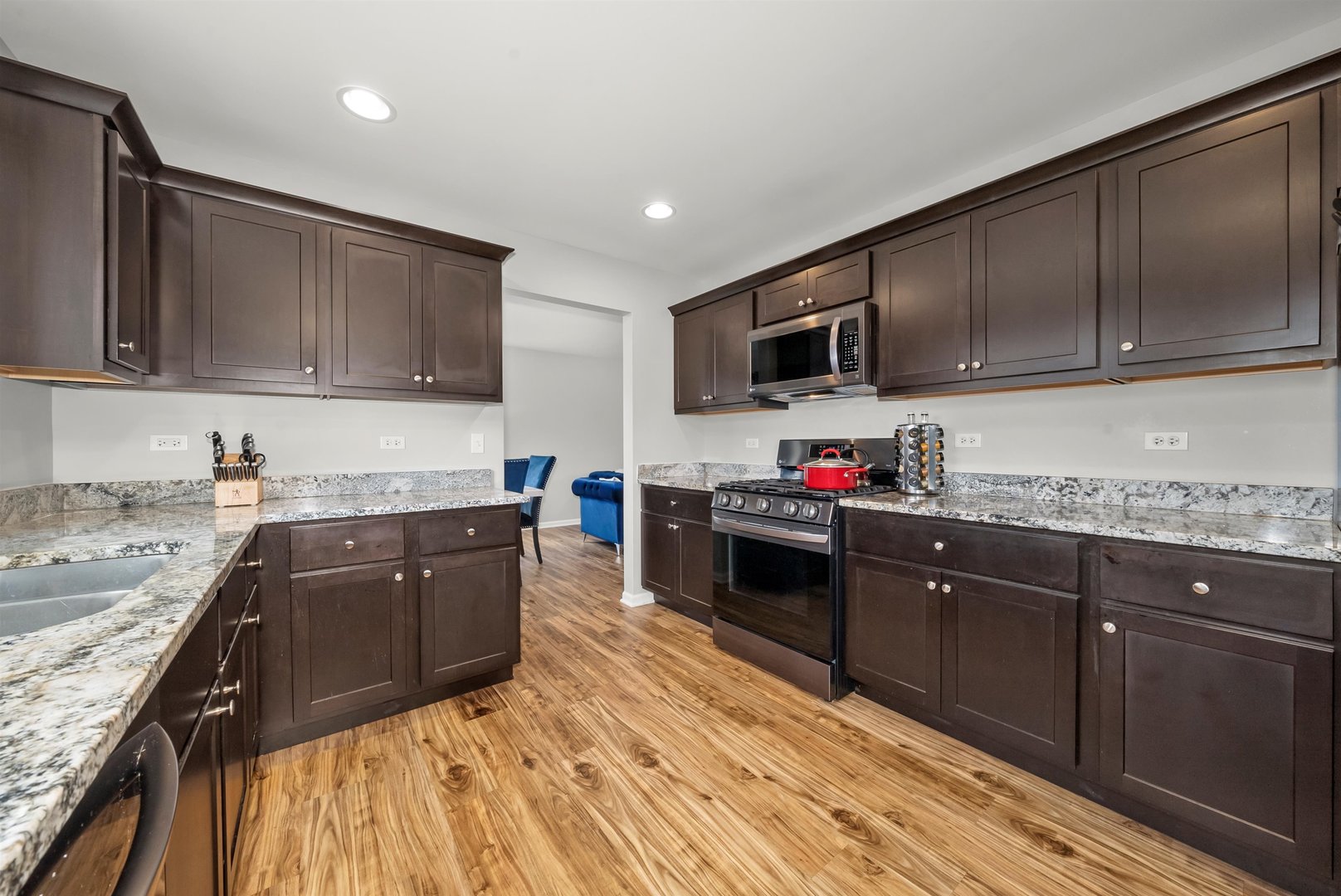 1516 Perry Street Crete, IL 60417 - Photo 9 of 35 a kitchen with granite countertop stainless steel appliances and wooden cabinets