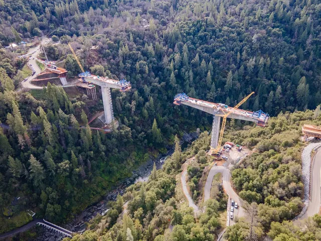 a view of a house with a yard and mountain