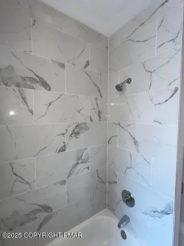 a view of bathroom with a sink and mirror