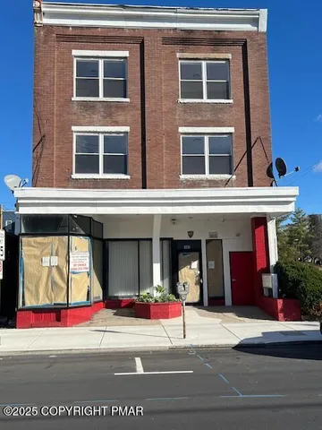 a view of brick building with many windows