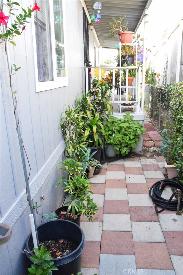 19850 Arrow Highway, Unit E6 Covina, CA 91724 - Photo 7 of 13 a view of a backyard with chair and the potted plants