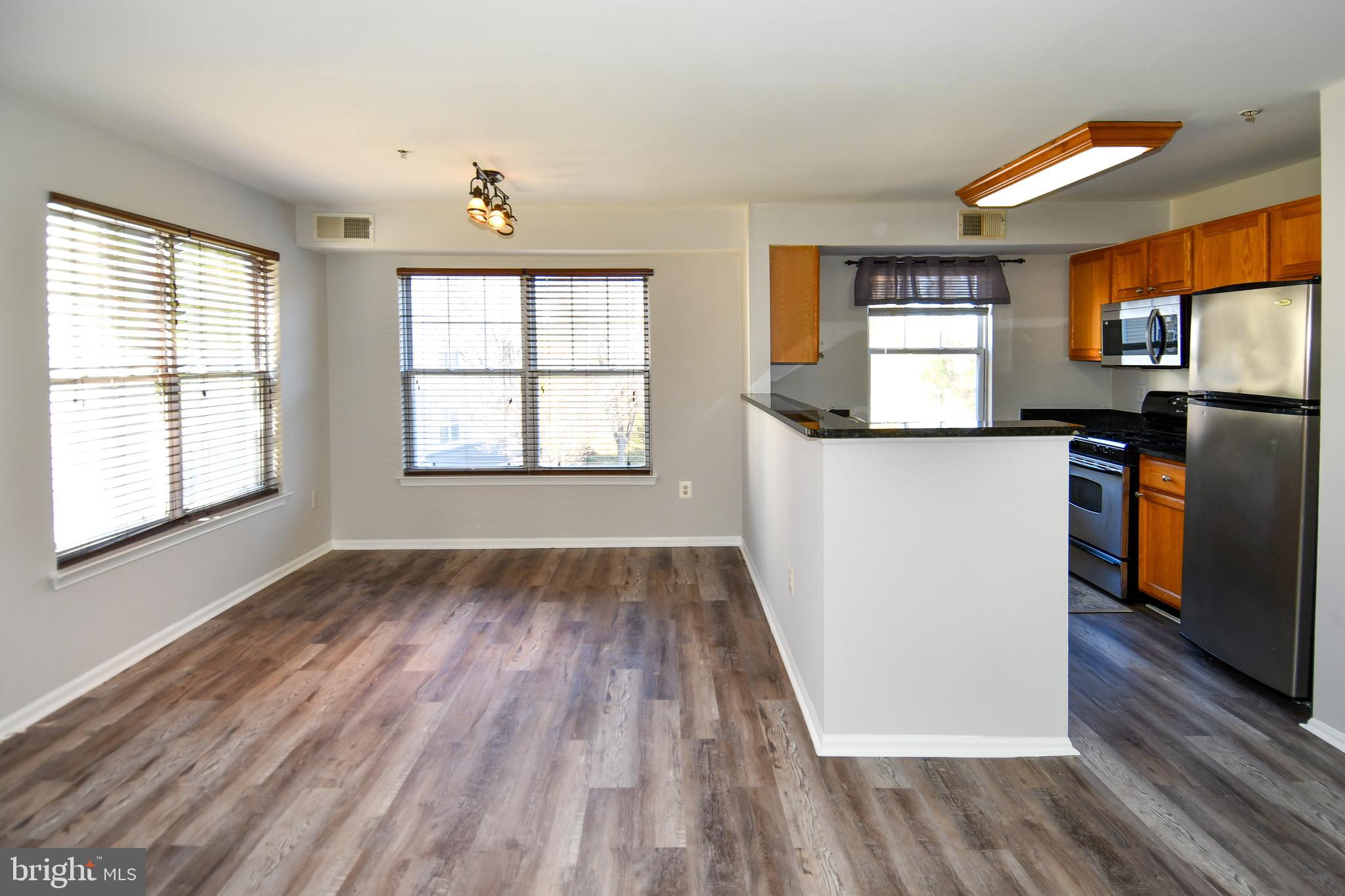 14100 Farnsworth Lane, Unit 2202 Upper Marlboro, MD 20772 - Photo 13 of 38 wooden floor in an empty room with a window and wooden floor