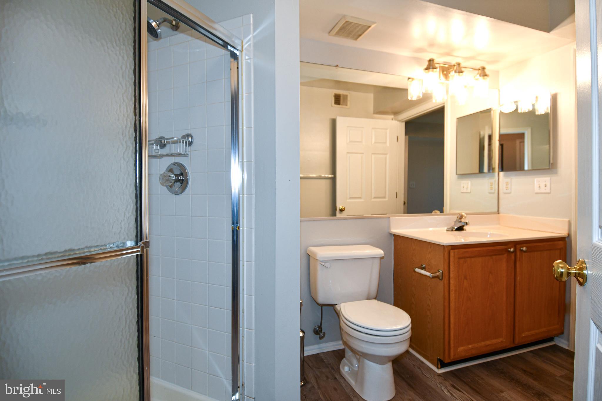 14100 Farnsworth Lane, Unit 2202 Upper Marlboro, MD 20772 - Photo 26 of 38 a bathroom with a toilet sink and mirror