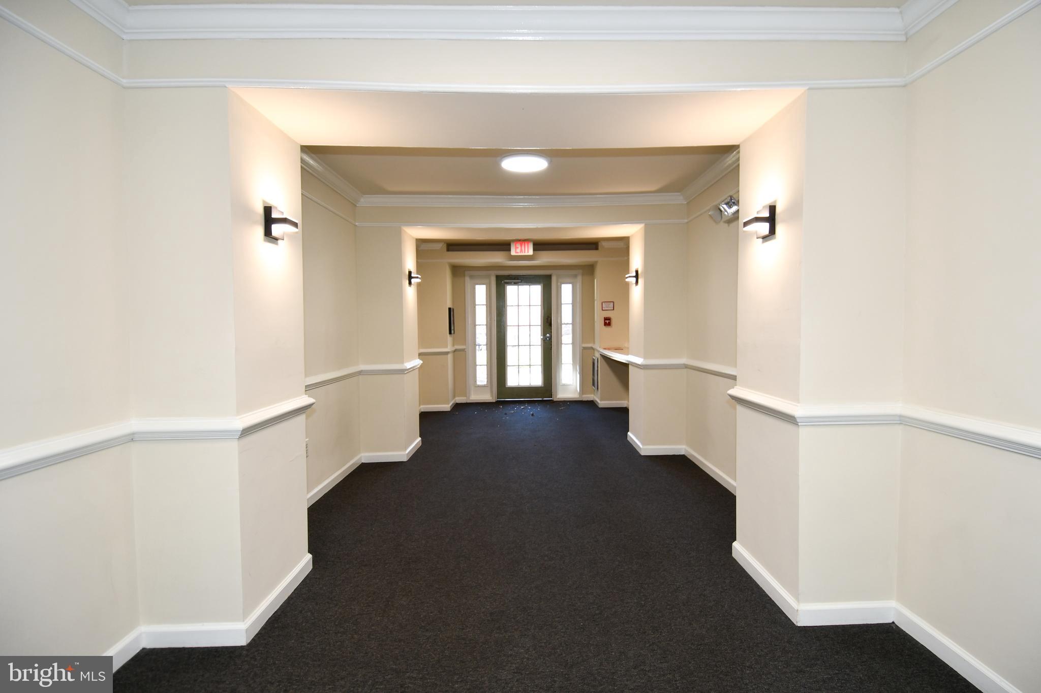 14100 Farnsworth Lane, Unit 2202 Upper Marlboro, MD 20772 - Photo 6 of 38 a view of a hallway with windows