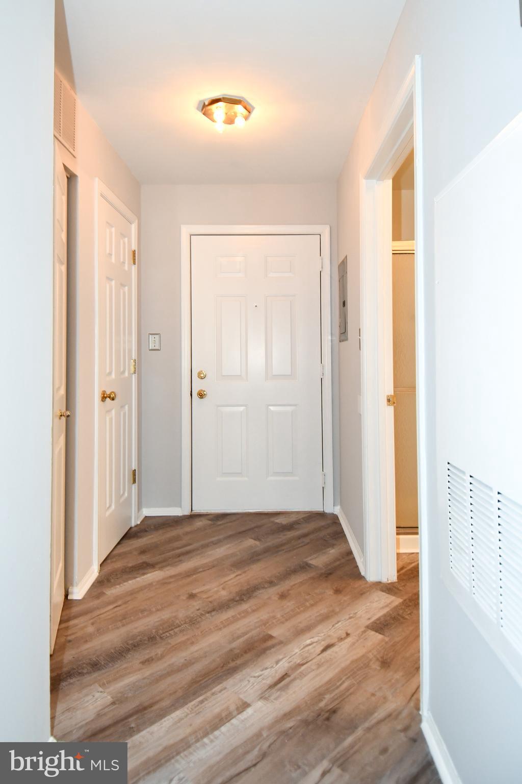 14100 Farnsworth Lane, Unit 2202 Upper Marlboro, MD 20772 - Photo 9 of 38 a view of an empty room with wooden floor