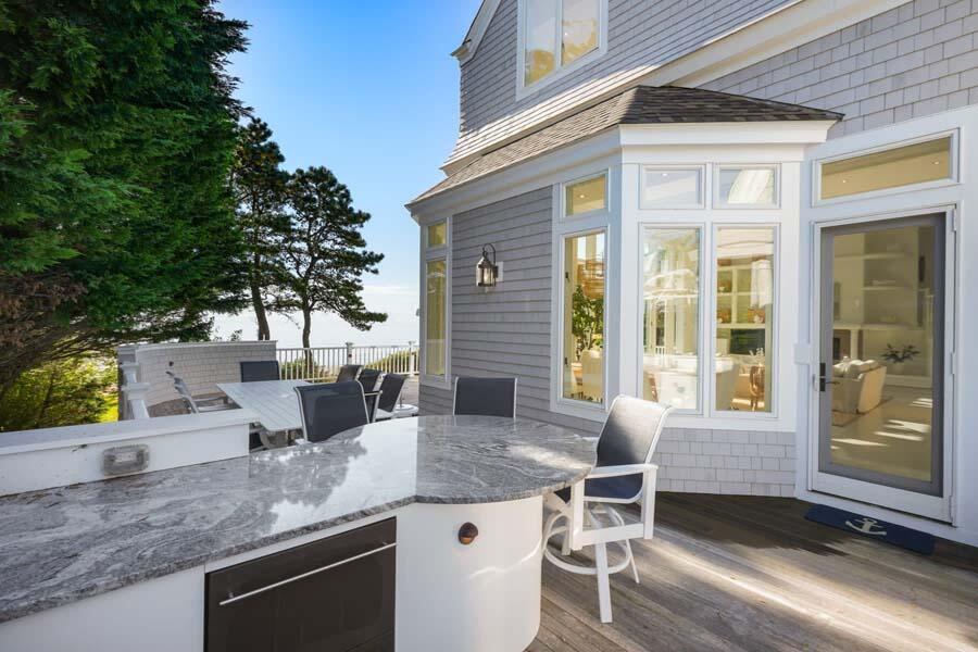 27 Ocean Bluff Drive Mashpee, MA 02649 - Photo 19 of 55 a view of a backyard with a patio and outdoor seating