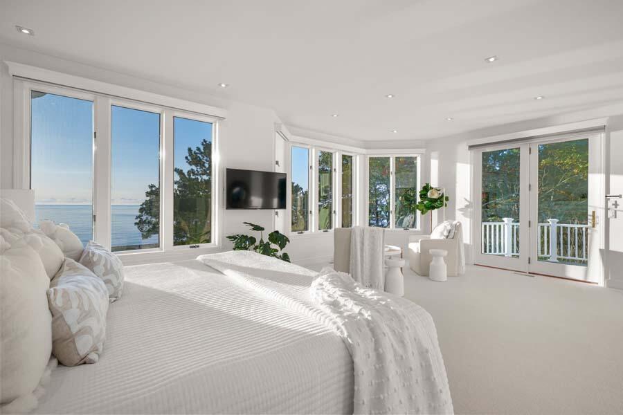 27 Ocean Bluff Drive Mashpee, MA 02649 - Photo 23 of 55 a bed sitting in a spacious bedroom next to a large window