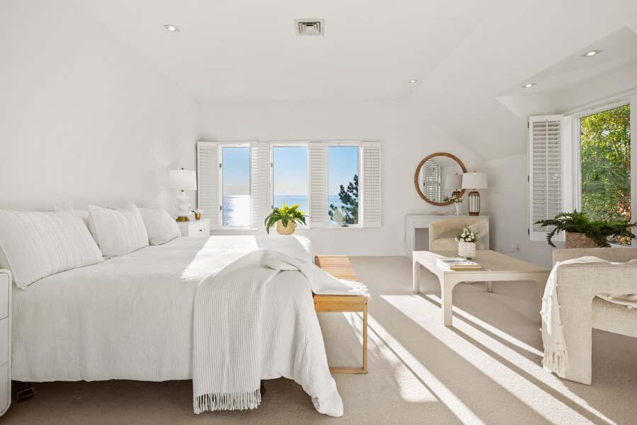 27 Ocean Bluff Drive Mashpee, MA 02649 - Photo 31 of 55 a living room with furniture a clock and white walls