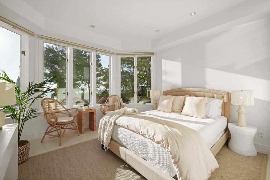 27 Ocean Bluff Drive Mashpee, MA 02649 - Photo 37 of 55 a bedroom with a bed and large windows