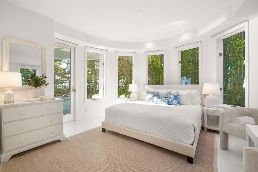 27 Ocean Bluff Drive Mashpee, MA 02649 - Photo 39 of 55 a bedroom with a bed and large windows