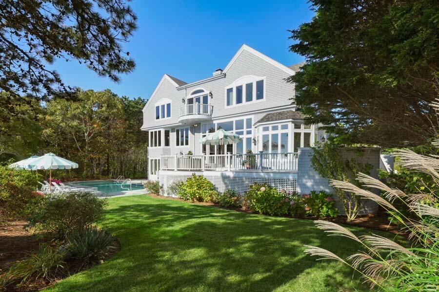 27 Ocean Bluff Drive Mashpee, MA 02649 - Photo 7 of 55 a front view of a house with a garden