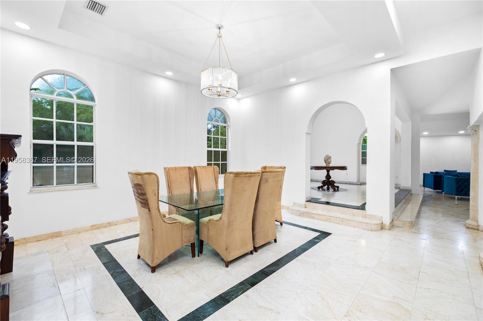 12300 Old Cutler Road, Unit 1 Pinecrest, FL 33156 - Photo 11 of 39 a view of a dining room with furniture a chandelier and window