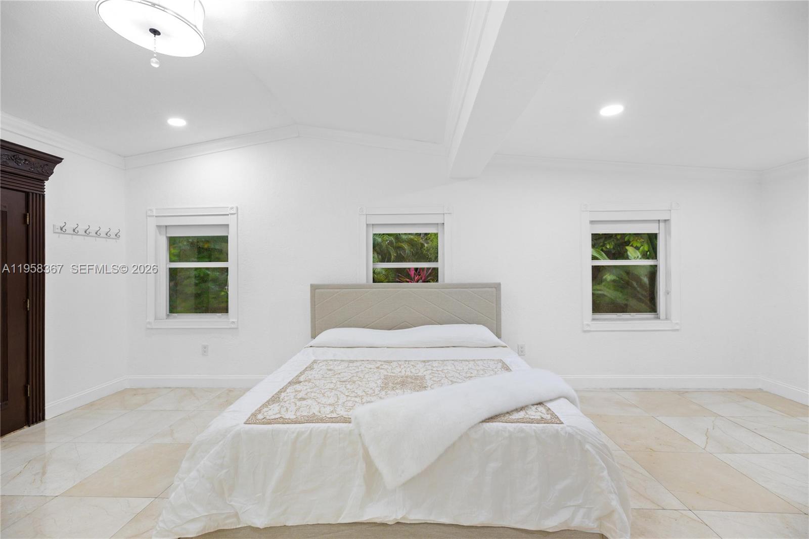 12300 Old Cutler Road, Unit 1 Pinecrest, FL 33156 - Photo 14 of 39 a bedroom with a large bed and a window