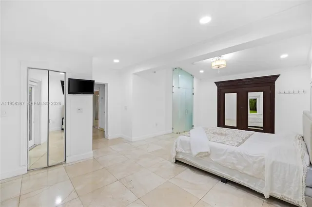 a spacious bedroom with a bed and a couch