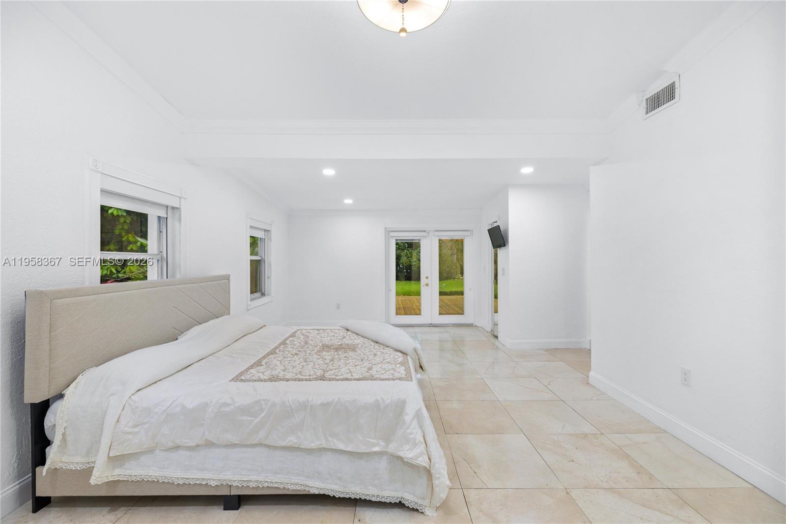 12300 Old Cutler Road, Unit 1 Pinecrest, FL 33156 - Photo 17 of 39 a spacious bedroom with a bed and a window